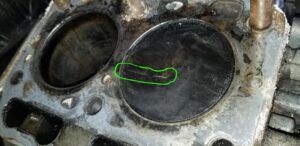 Hard starting led to a tear down and the discovery of a cracked piston crown (green highlight).