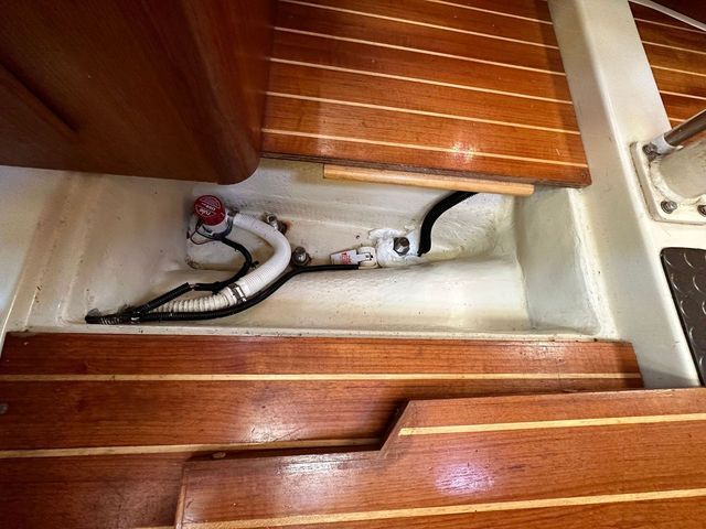 A removable panel in the cabin sole conceals a generous sump for the bilge pump. The boat's structural hull pan protrudes above the sole. (Photo/ Bert Vermeer)