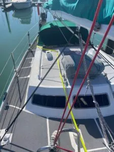 A helpful view of the jackline leading around the dodger to a hard point on top of the coach roof, and from there forward to the base of the mast.