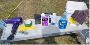 All of the materials needed to redo your boat lettering are easy to find and affordable. The hardest part is choosing the boat name! From left to right: hairdryer, scraper, plastic spatula, masking tape, acetone, rubbing alcohol, dish soap, bucket and lint free towel.