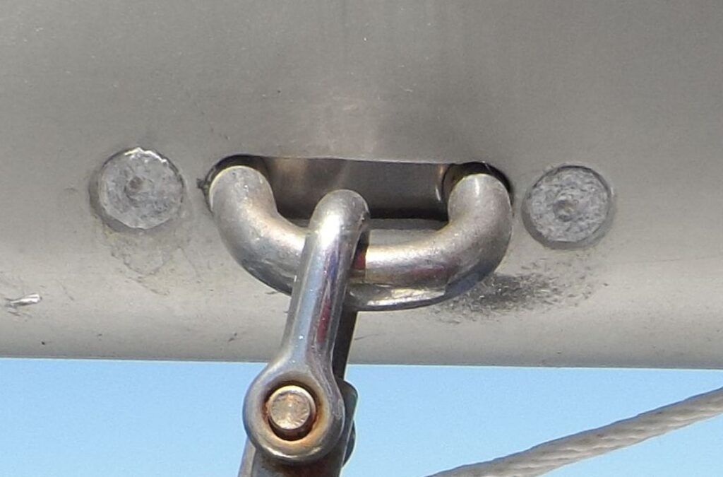 Aluminum rivets were used to restrain this mainsheet padeye. Although the spar was saved from corrosion, the rivets are devastated. Good thing there is little stress on the rivets. (Photo/ Drew Frye)