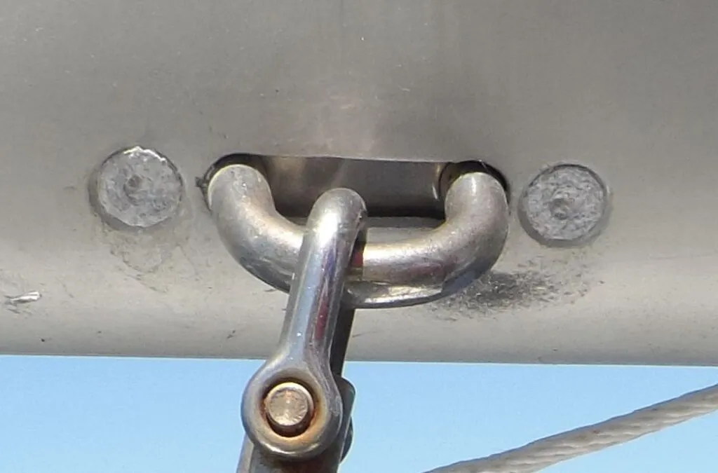 Aluminum rivets were used to restrain this mainsheet padeye. Although the spar was saved from corrosion, the rivets are devastated. Good thing there is little stress on the rivets. (Photo/ Drew Frye)