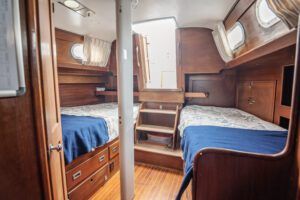 The aft owner's stateroom features two 6-ft. 6-in. berths with storage drawers underneath. You have easy access from the aft cabin to the aft cockpit and the galley. Photo courtesy of Forbes Yachts. 