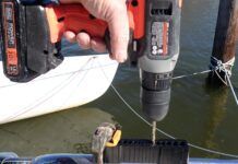 A V-Guide in use on stainless pulpit railing. V-Guides keep your drill bit from walking off either side of the curved surface. They are a helpful tool in this scenario since stainless requires steady, slow, lubricated pressure to drill properly.