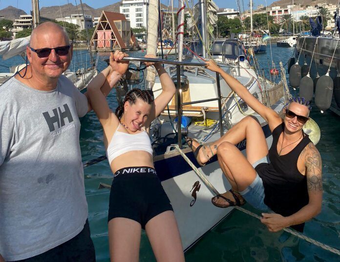 Leszek Wolnik, left, with granddaughter Reija, center, and crew Marija before their Atlantic crossing on a Vancouver 32. Reija and Marija had their hair braided in preparation for the voyage, while Leszek's hair was naturally voyage-ready. (Photo/ Leszek Wolnik)