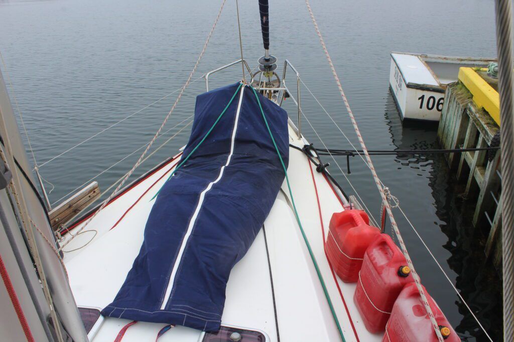 Staysail in it's "body bag." When the dinghy is stowed on deck, the body bag is secured on top of the dinghy. When we bought the staysail, the sailmaker from Ulman gave us an unused sail bag which Amanda cut up and restitched. He also gave us offcuts of trampoline netting which Amanda sewed on to the bottom for drainage. We bought the zip and stainless steel slider from Ulman for about $70. We already had thread and velcro onboard—probably about ten bucks worth. (Photo/ Brett Campbell)