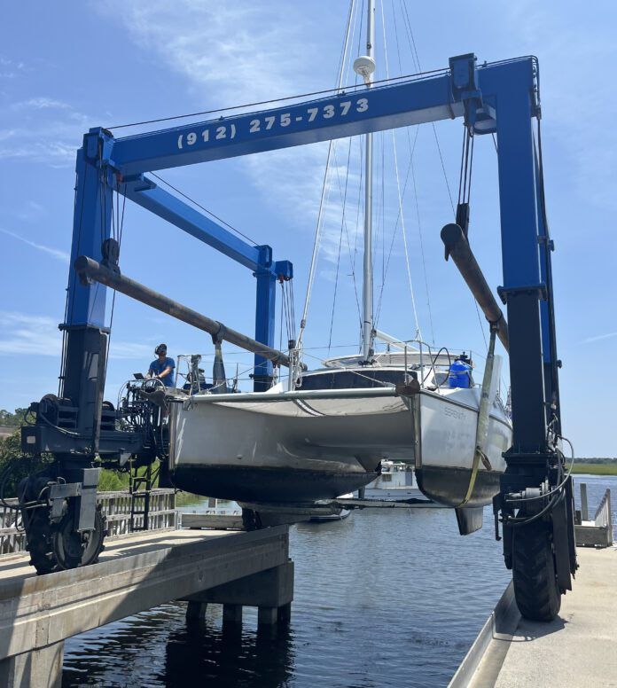 This flight in the travel lift from the water to the stands cost at Brunswick Landing Marina cost $814 with a pressure wash of the bottom included. (Photo/ Alex Jasper)