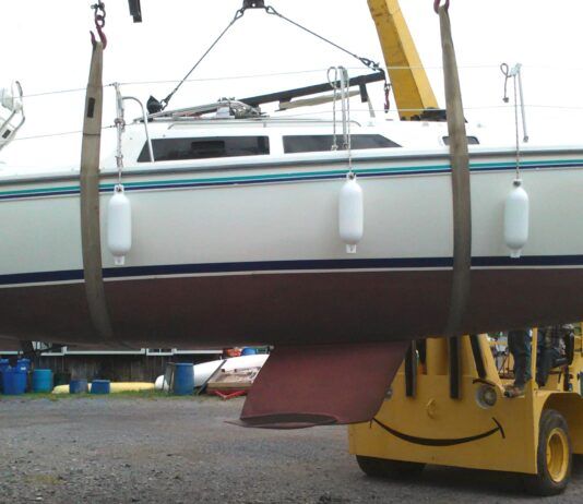 The author's Catalina 270, Aquaholic, on slings. You can easily see where the slings are properly set. Even the crane seems happy! (Photo/ Marc Robic)