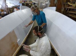 "The epoxy primer was applied quickly by Jacob and Hanneke, one rolls it on the other strokes it out. We applied two coats and afterwards wet-and-dry sanded them." (Info/Photo Wharram Designs)