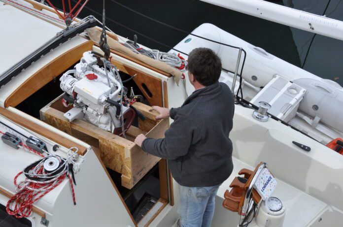 Lowering the Beta 20, the Kubota 722 block marinized by the British, to replace a Volvo MD7A two-cylinder. (Photo/ Bert Vermeer)